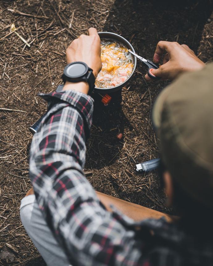 person cooking on stainless steel bowl